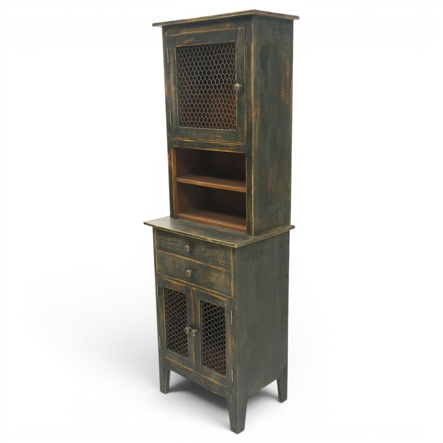 20th century pine kitchen cabinet in a green painted finish, top section with upper door with wire front above a recessed shelved area, the lower section with two drawers and twin wire fronted doors, raised on tapered supports