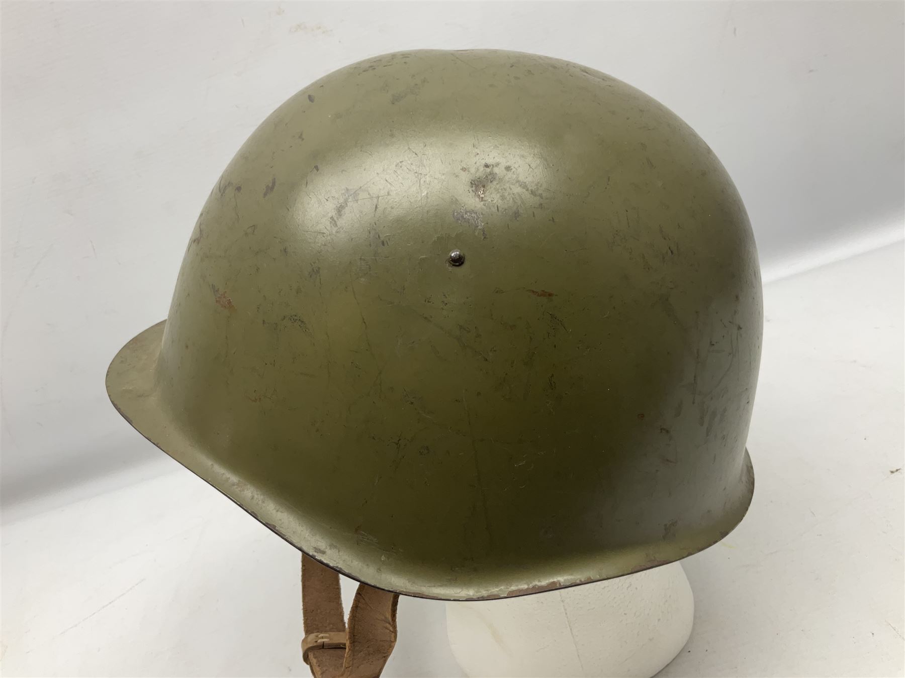Two 1960s East Block Soviet style helmets - Czechoslovakian and Russian; both with liners (2)