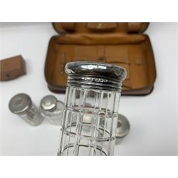 Mappin & Webb leather cased campaign gentleman's vanity set, the tan leather case opening to reveal fitted interior with five engine turned silver capped glass vanity bottles, hallmarked Mappin & Webb, London 1944, brushes, mirror etc, monogram DPK to the top of the case
