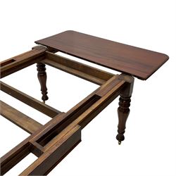 19th century mahogany extending dining table with three additional leaves, rectangular top with rounded corners, pull-out action, on turned and faceted supports with brass castors