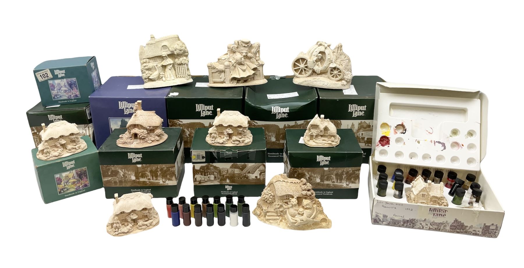 Ten Lilliput Lane models from the 'Paint Your Own' collection, to include cottages and plaques, all boxed, to include one boxed model with paints and brushes and a further box of paints