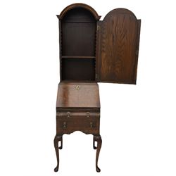 Small early 20th century Queen Anne style bookcase on bureau secretaire, the moulded arched pediment over mirrored door in shaped frame, the bureau fitted with fall front enclosing curved fitted interior, cushion moulded drawer over single drawer, on scroll and shell carved cabriole supports