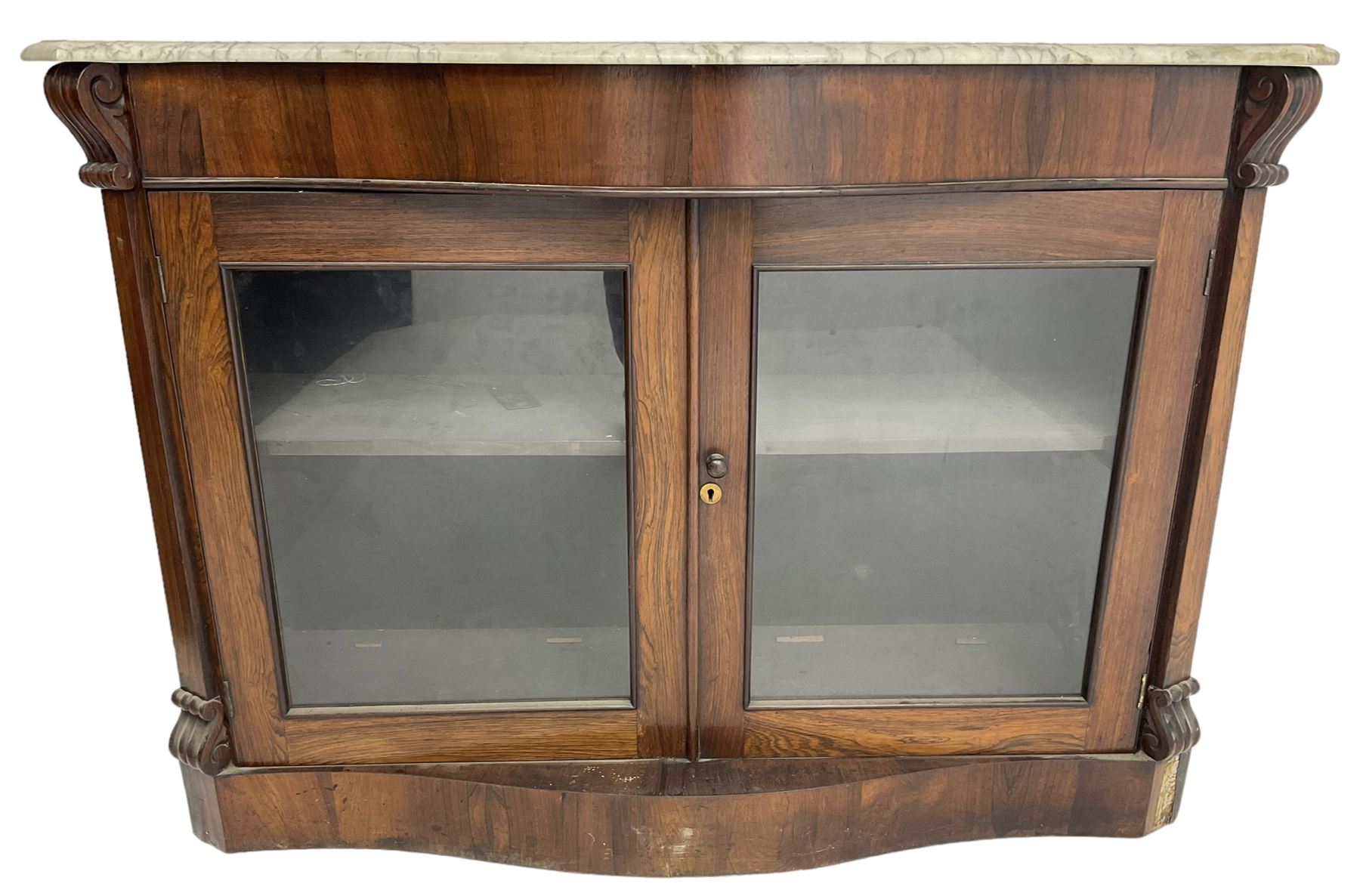 Victorian rosewood side cabinet, shaped and moulded white marble top over plain frieze, single shelf enclosed by two glazed doors, flanked by square pilasters with S-scroll carved brackets, on plinth base
