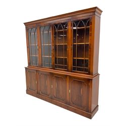 Georgian design yew wood bookcase on cupboard, four glazed doors above four cupboards, adjustable shelves
