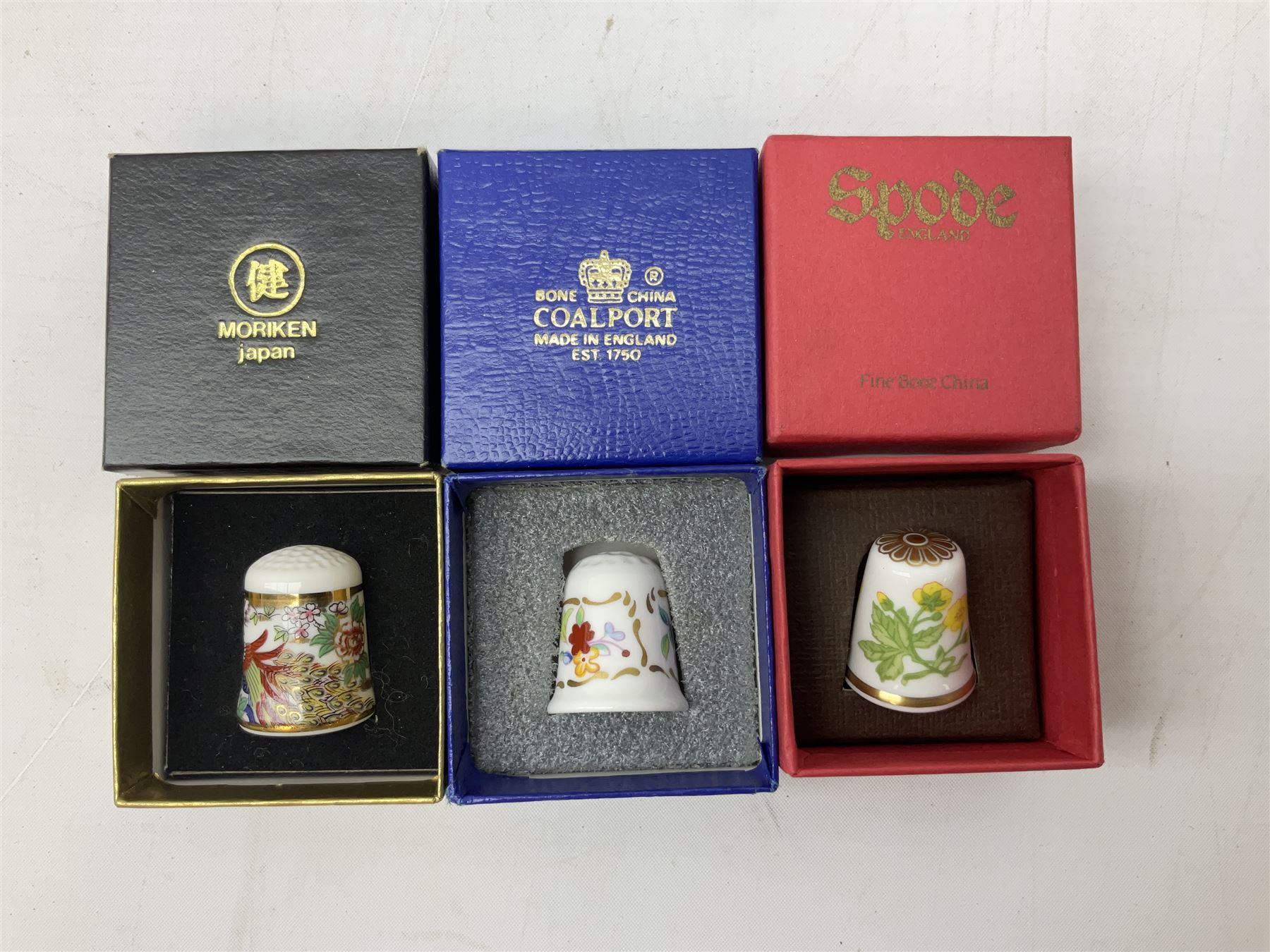 Quantity of thimbles to include twelve Irish Dresden lace examples, Royal Crown Derby, Spode, Portmeirion, Wedgwood, Royal Grafton etc, together with three display cases, many with certificates