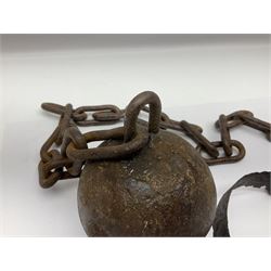 Late 19th/early 20th century prisoners iron ball and chain, with leg manacle; small cannon ball and grape shot