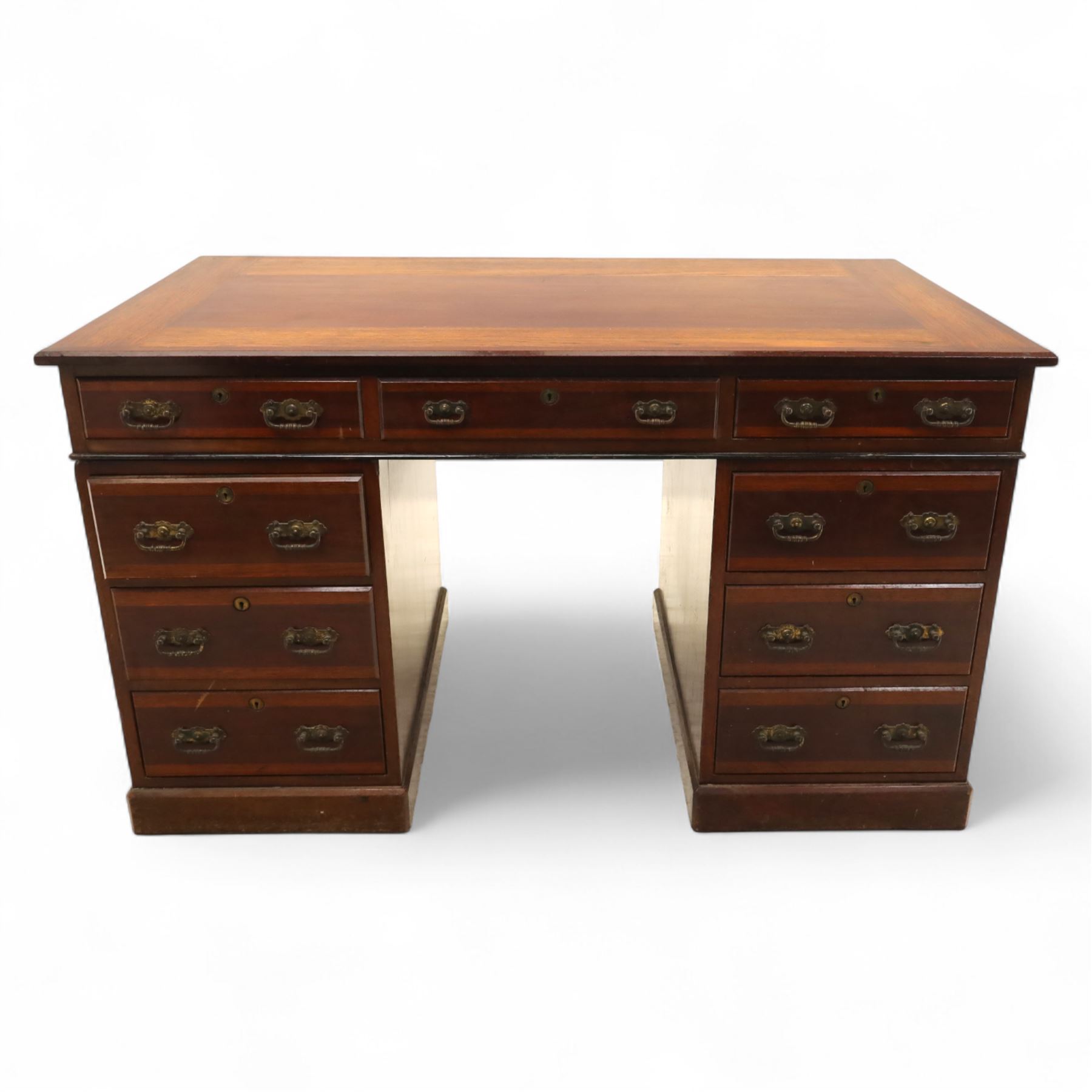 Early 20th century Indian hardwood pedestal desk, rectangular top with moulded edge over three frieze drawers, twin pedestals each fitted with four drawers, brass pierced swing handles and brass escutcheons, upon plinth bases  