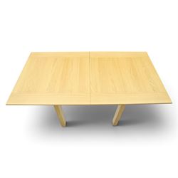 Contemporary light oak extending dining table, the square top with pull-out and fold-over action, raised on square supports