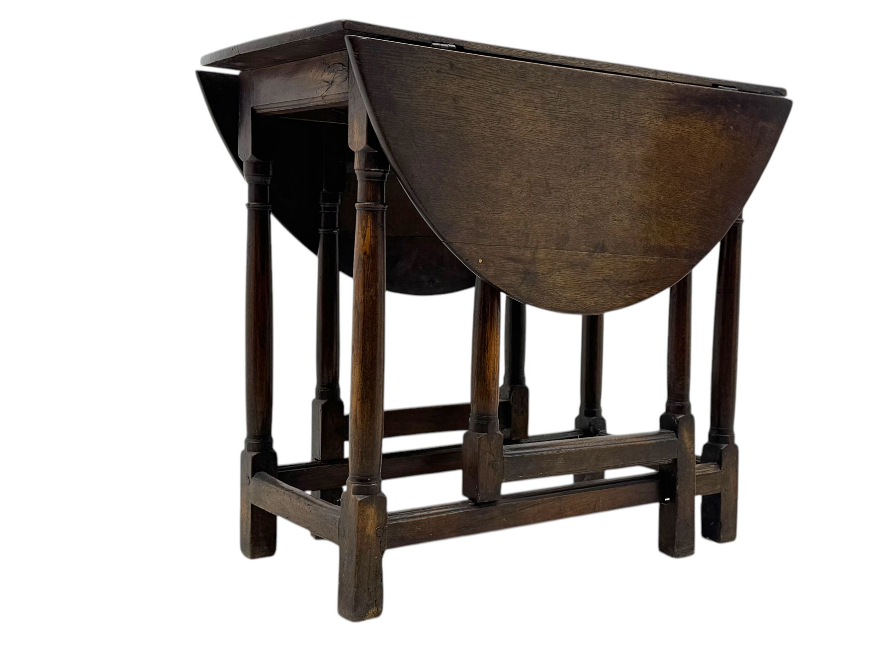 19th century oak gateleg table, the oval drop-leaf top formed of four planks, on turned column supports united by rectangular stretchers