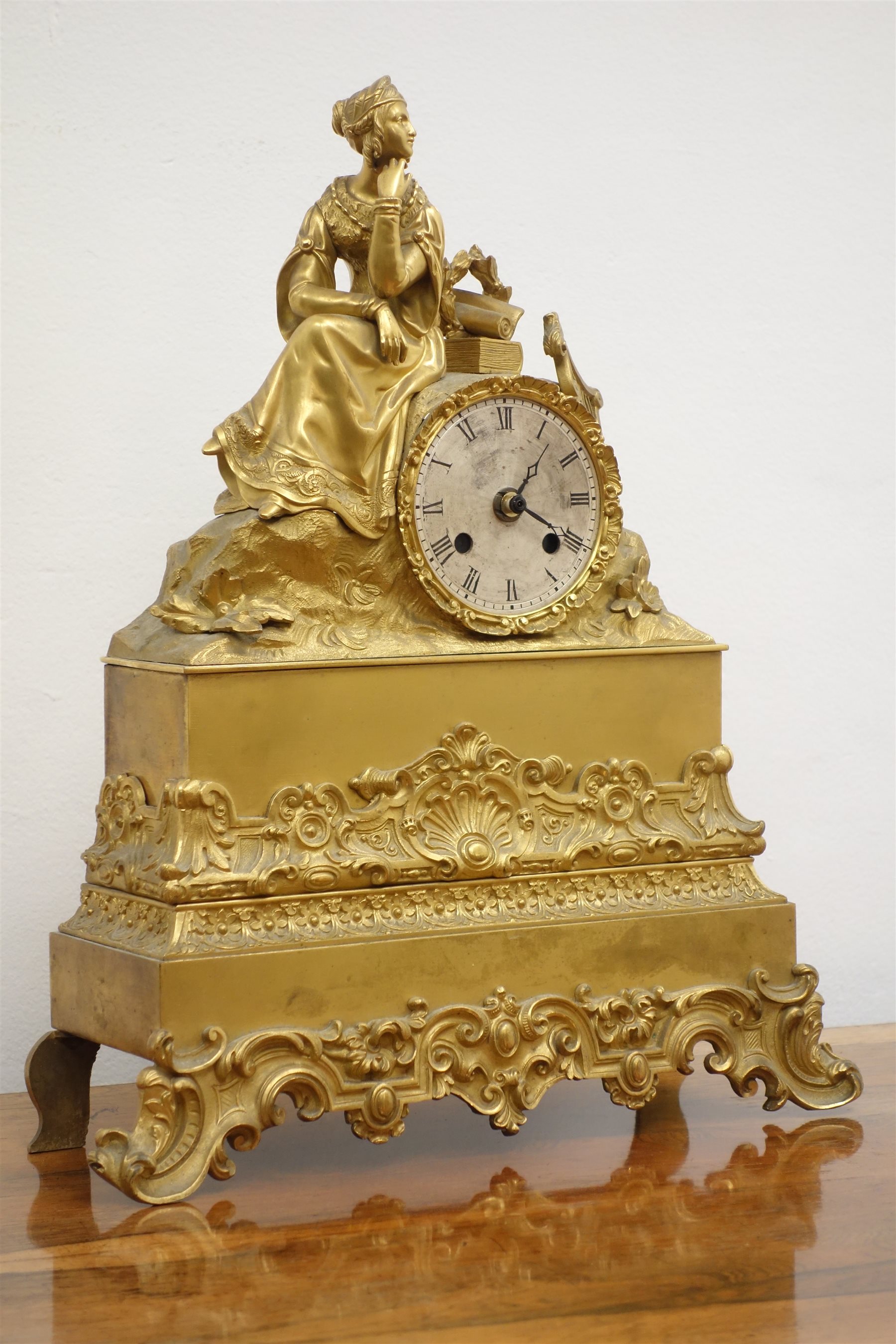Late 19th century French gilt metal figural mantel clock with seated
