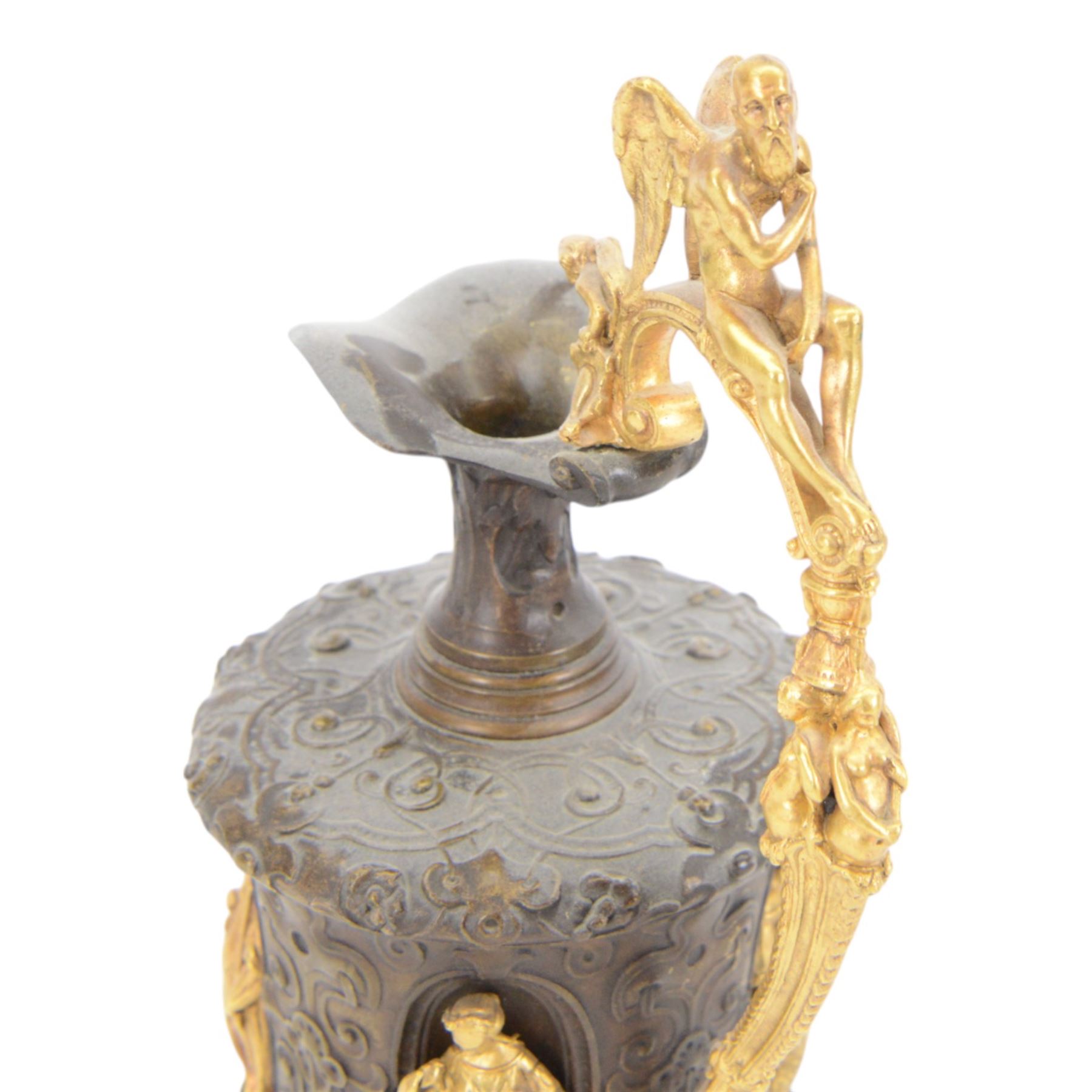 Pair of bronzed and gilt ewers in the Neo-Classical taste, each of typical form with figural detailed and mounted scroll handle surmounted by a winged figure, the bodies cast with scrolling strapwork, flower heads and acanthus leaves, and further detailed with applied gilt classical figures to oval recesses, upon a knopped stem and spreading circular foot with conforming cast detail, H28cm