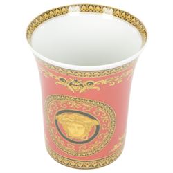 Rosenthal Medusa Versace vase, featuring a gold-shaded Medusa head surrounded by baroque details upon a red ground, H18cm 
