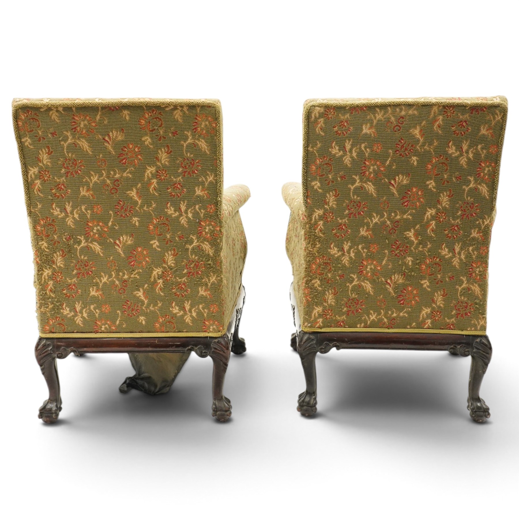 Pair of Chippendale design carved mahogany framed armchairs of stylised lyre form, high square backs and sprung seat upholstered in olive-ground foliate fabric, scrolled arm terminals with applied rosettes, the seat rail moulded with central scallop-and-acanthus motif, raised on shell-carved cabriole supports with ball-and-claw feet