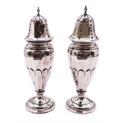 Pair of 20th century silver casters, each of faceted slender ovoid form with pierced domed cover, upon filled circular stepped foot, hallmarked Gorham Manufacturing Co, Birmingham 1913 or 1938, H5.5cm, approximate gross weight 7.47 ozt (232.4 grams)