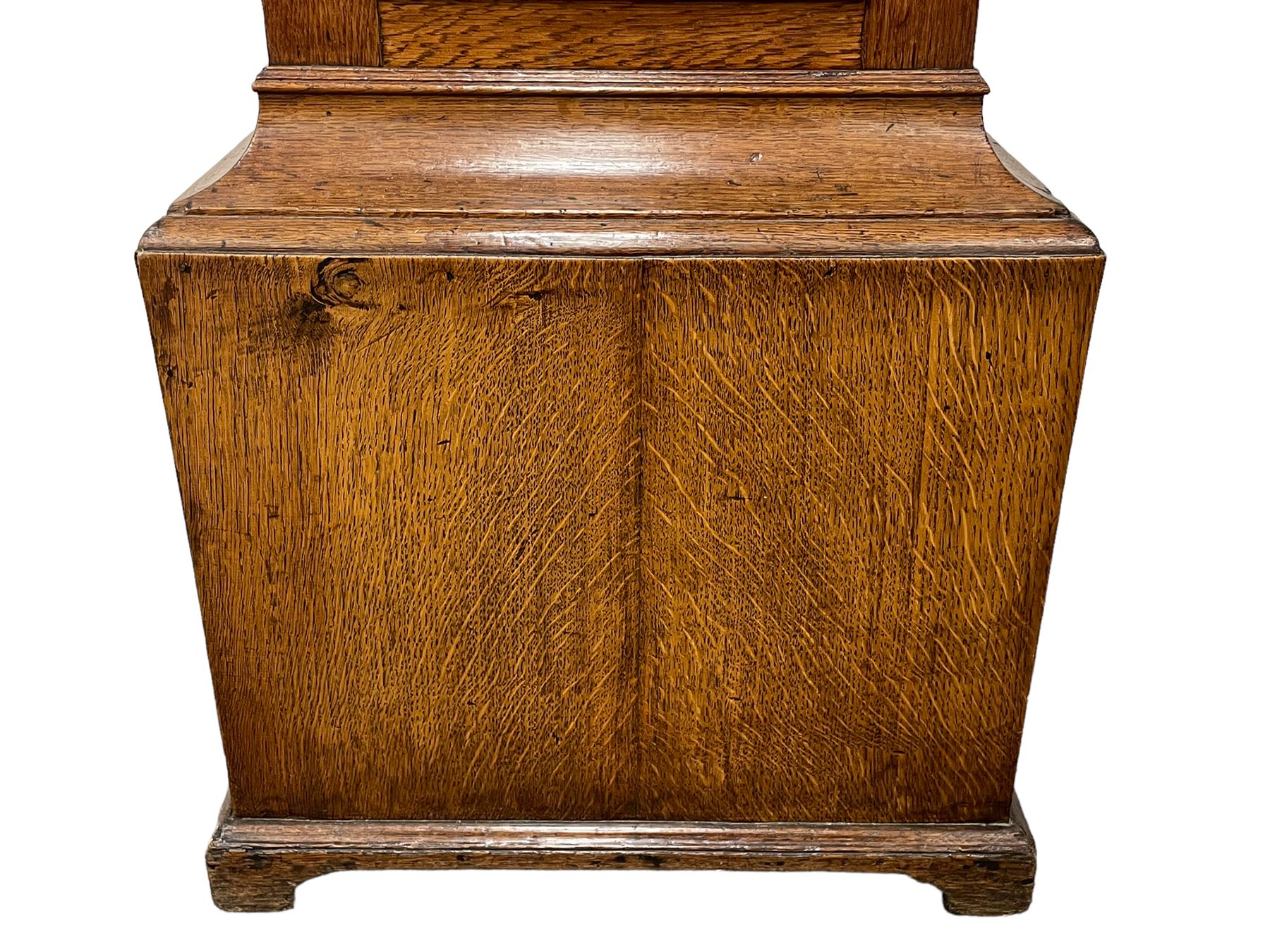 Henry Hindley of York – mid-18th century oak cased 8-day longcase clock,
flat topped caddy pediment with gesso finials, rectangular hood door flanked by wooden turned pilasters with capitals, canted trunk with a full-length break arch topped door on a short plinth with applied skirting and bracket feet, brass dial with a silvered chapter ring, Roman numerals and five-minute Arabic’s, minute and inner quarter hour tracks, matted dial centre with subsidiary seconds dial, blued steel hands and female head pattern spandrels, silvered calendar dial to the break arch with dolphin spandrels, four pillar rack striking movement, striking the hours on a bell. With weights and pendulum. 
H250 W48 D27
Henry Hindley originally from Wigan (Lancs) is recorded as working in York from Petergate 1731-41 then Stonegate 1741-1771. A famous and highly innovative maker, often referred to as the “Tompion of the North.” 
