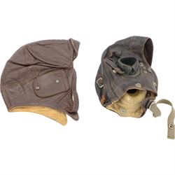 WWII leather air force flying helmet, together with one other leather helmet