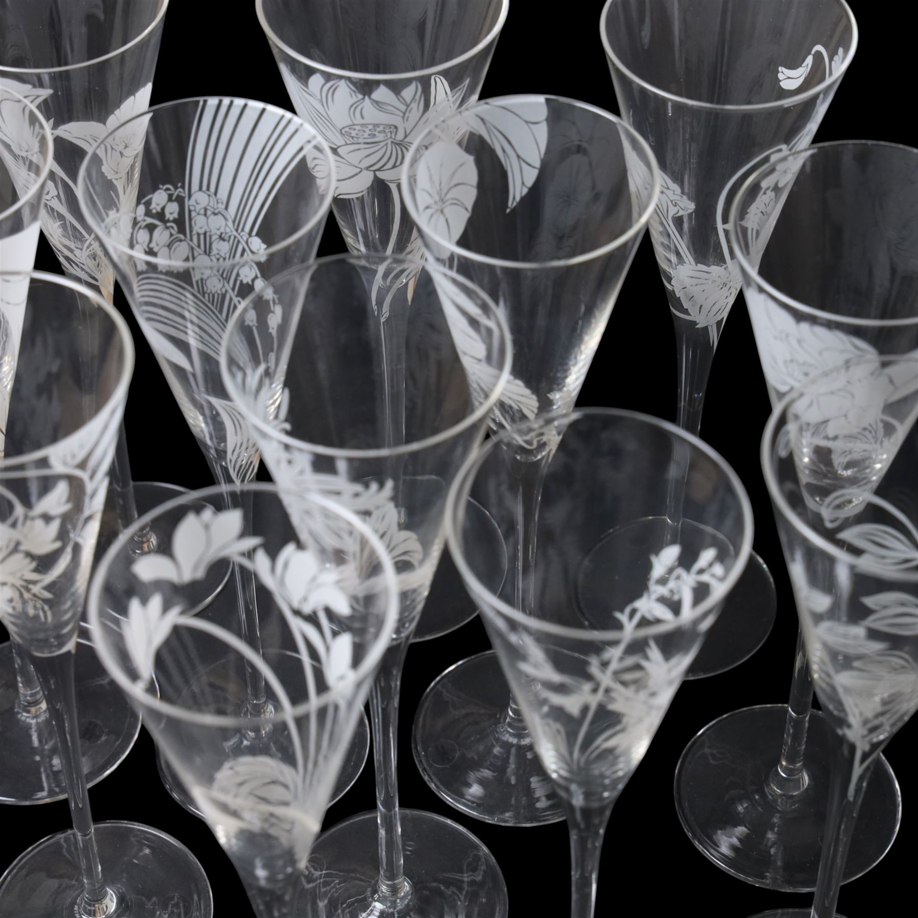 Twelve Crystal champagne glasses Les Fleurs, issued by the Franklin Mint in collaboration with Perrier Jouet, each glass is etched with a different flower, all boxed 