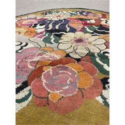 20th century wool oval rug, mustard ground and decorated with flower heads, with pink and green outer bands