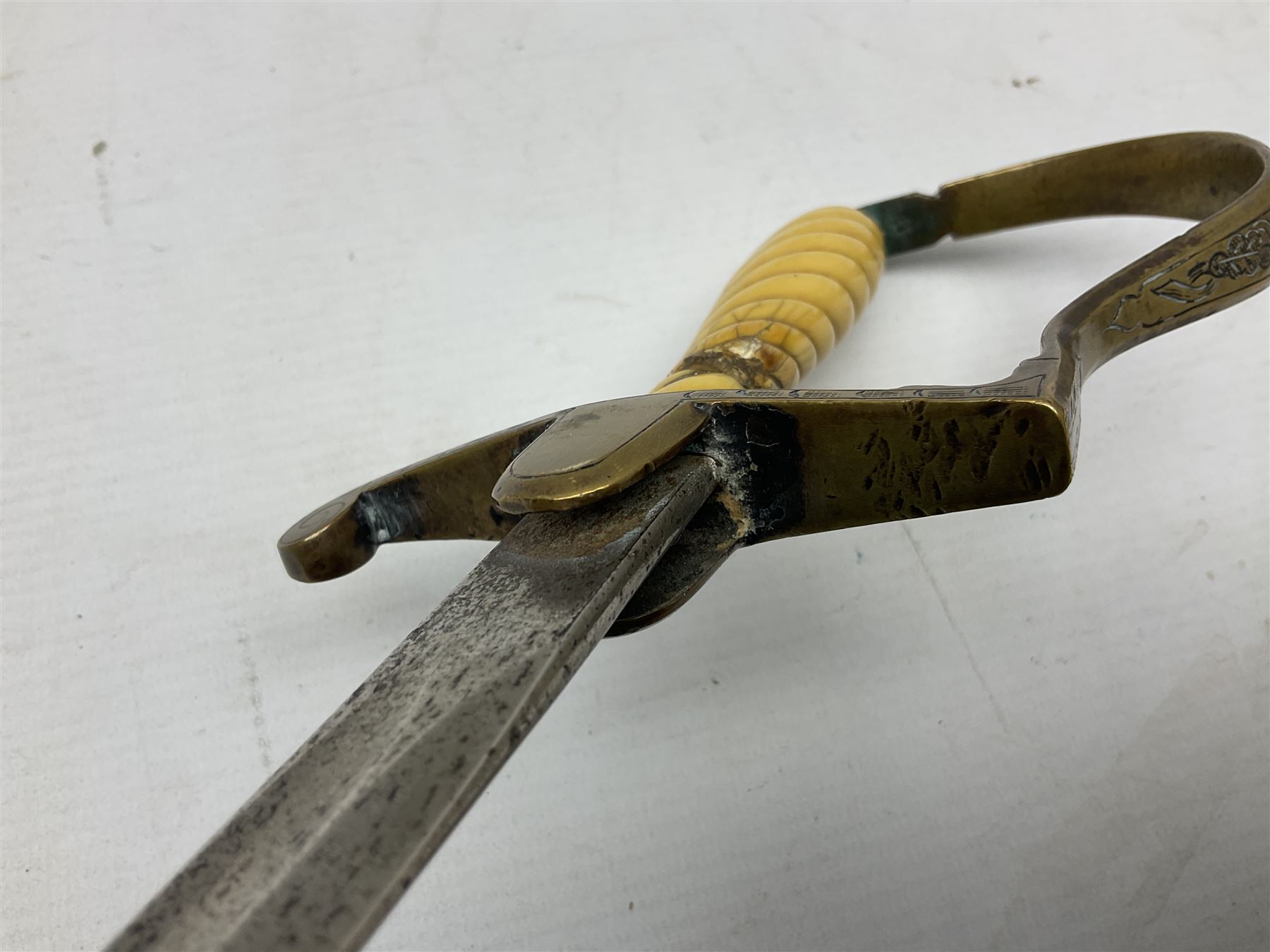 1900-1918 German Imperial NCO sabre with WW2 modifications of Wehrmacht insignia to the langet, 79cm slightly curving fullered blade and brass hilt, the knucklebow chased with oak leaves and acorns L90.5cm overall
This item has been registered for sale under Section 10 of the APHA Ivory Act 