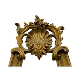 Early 20th century giltwood and gesso floor standing picture easel, the shell pediment surrounded by acanthus leaves and surmounted by flower heads, supported upon a moulded frame with shell and foliate moulded middle rail, the terminals decorated with acanthus leaves and scrolls 