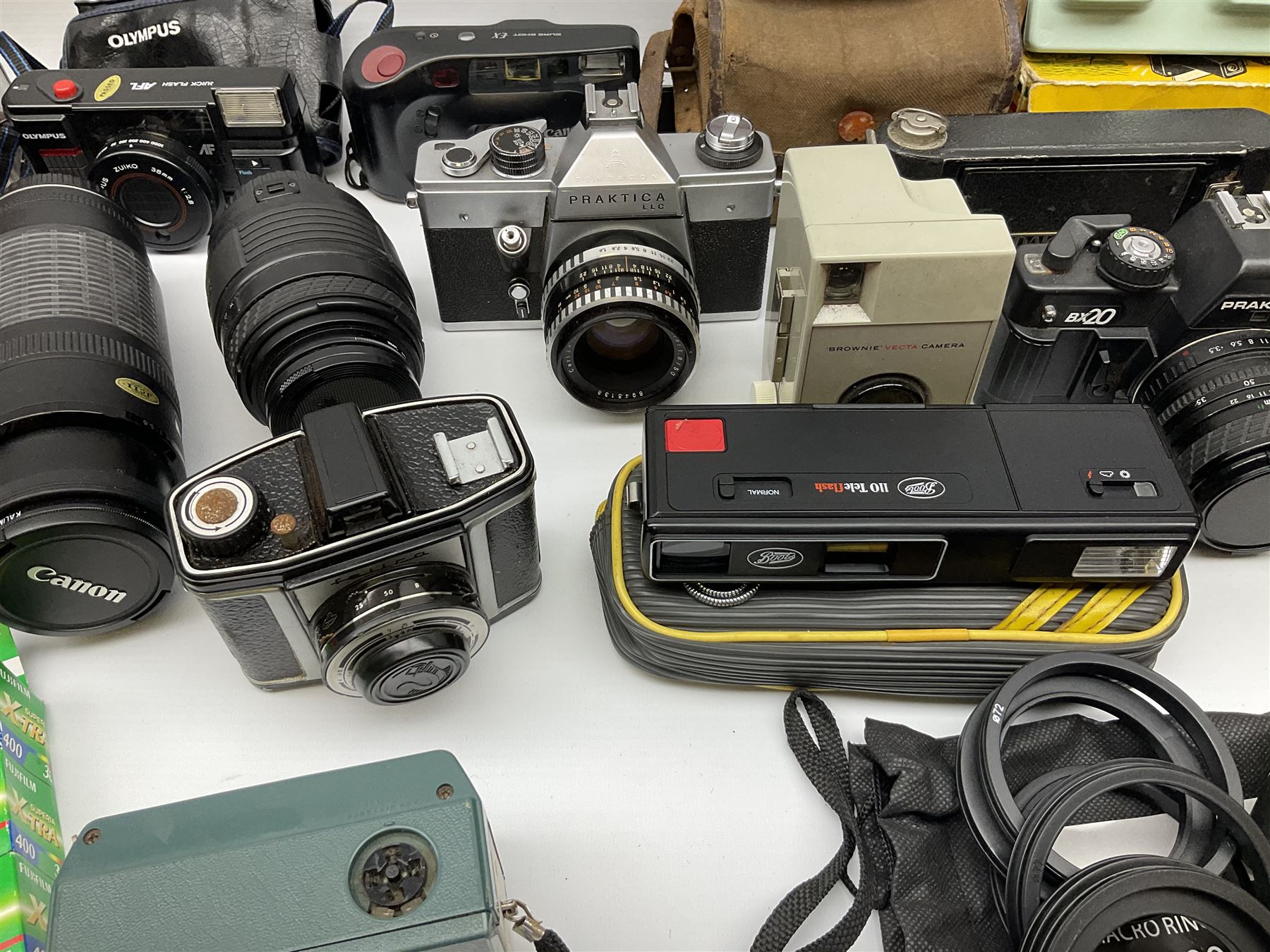 Vintage and later cameras, lenses, accessories and darkroom equipment including Zenit 12XP camera, Praktica BX20 camera fitted with 'Sigma Zoom Master 1:3.5-4.5 f=35-70mm' lens, Praktica LLC camera fitted with 'Carl Zeiss Jena Pancolar 1.8/50' lens, Canon Zoom Lens 'EF 100-300mm 1:5.6', various Jessop and other makers darkroom items including safelight (Red), universal duo tank, multi-mask enlarging easel etc, in three boxes