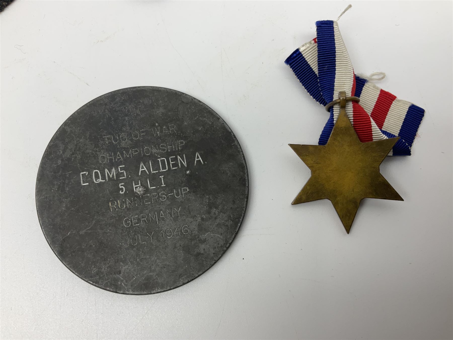 WW2 Highland Light Infantry Military Medal group of five comprising MM, 1939-1945 War Medal, Defence Medal, 1939-1945 Star and France and Germany Star; three with ribbons; awarded to 1702538 A. Sjt. A.L. Alden H.L.I.; various copies of his citation giving details of his bravery on 26 Sep 44 at Donderdonk France when he single-handedly silenced an enemy machine gun nest. The citation also mentions a further heroic act on 15 Nov 44 when he risked his life to obtain vital information on the position of enemy mines and booby traps saving the lives of many other soldiers; the collection also comes with two contemporary group photographs of his Highland Light Infantry regiment, copy photograph of him being awarded the MM by Field-Marshall Montgomery, two post-war tug-o-war medallions and other items; together with a shooting medallion awarded to Gnr. J. Alden (his brother John) inscribed 123 L.A.A. Regt. R.A. Rifle Meeting Harburg 1945 and a Life Saving bronze medallion to J. Alden April 1938