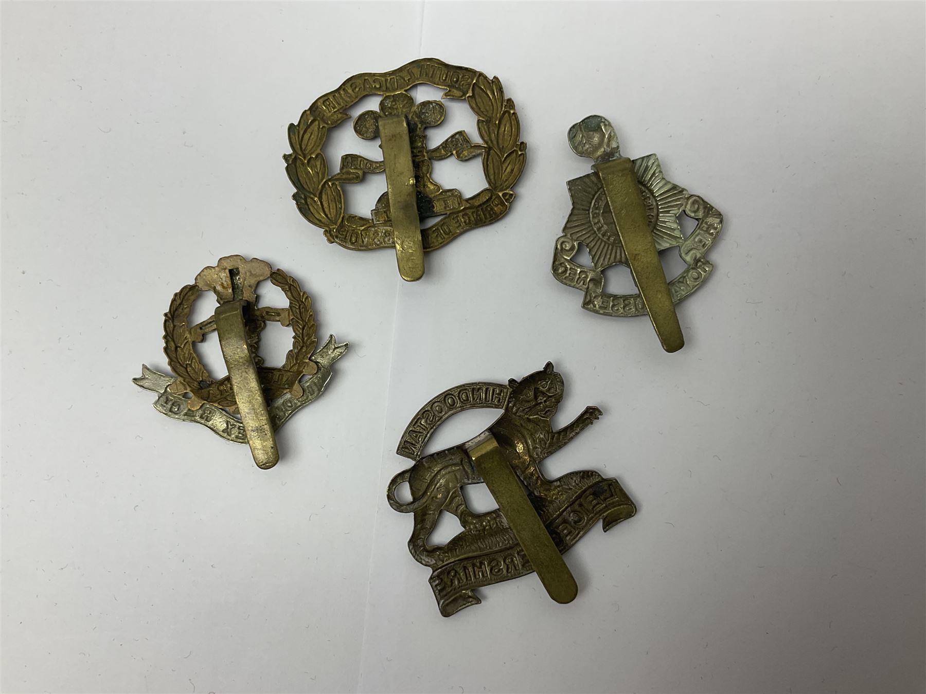 Seventeen regimental cap badges including Dorsetshire, Worcestershire, Staffordshire, Lancashire, Manchester, Middlesex, Berkshire, Bedfordshire etc (17)