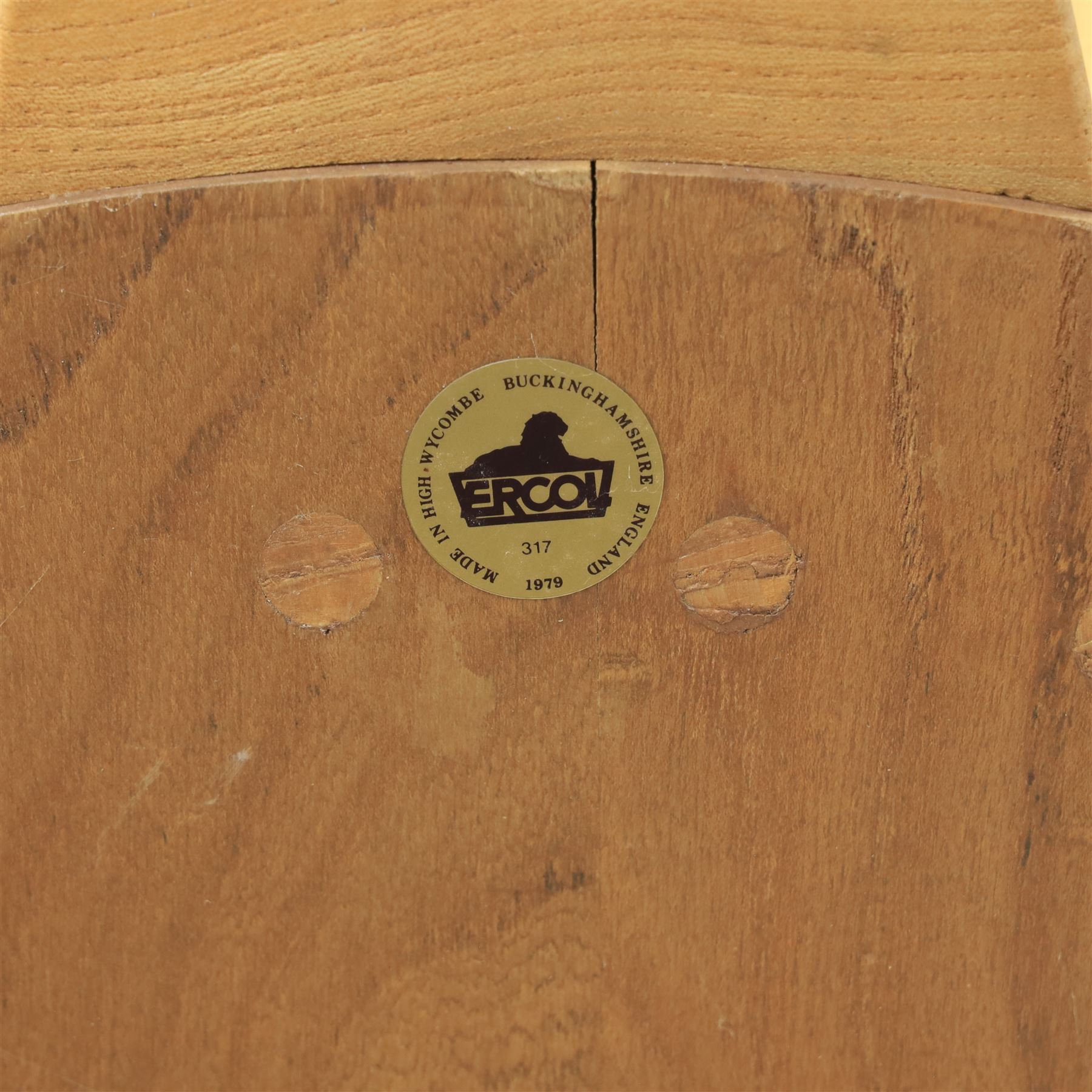 Ercol - Mid 20th century elm and beech Windsor armchair, the hooped spindle back over a shaped elm seat, with scroll front armrests on turned supports, raised on splayed tapering legs united by stretchers, lacking loose seat cushion