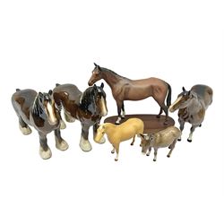 Four Beswick horse figures, comprising Quarter Horse, two Shires no 818 and matt palomino, together with Beswick donkey and Royal Doulton horse on a wooden plinth  