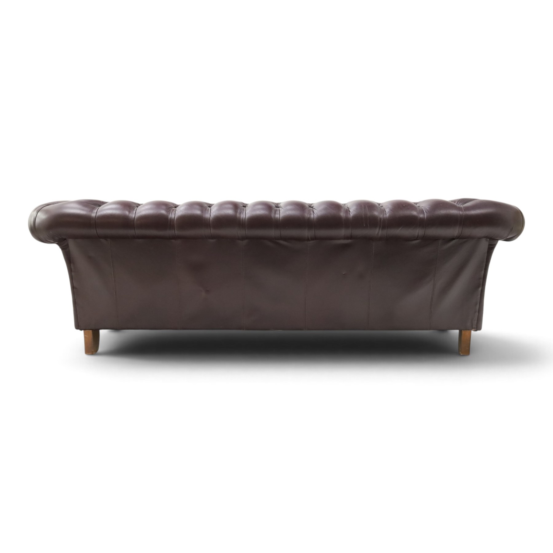 Thomas Lloyd - traditional shape Chesterfield two seater settee with rolled back and arms, upholstered in buttoned deep oxblood leather with loose seat cushions, raised on turned feet