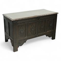 19th century carved oak coffer, rectangular plank top above a four-panel front carved with...