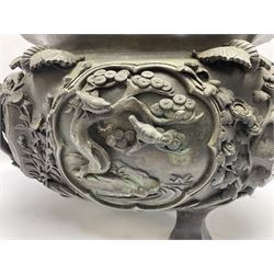 Large Japanese Meiji period bronze jardiniere, cast in high relief with panels depicting birds perched and flying around flowering prunus branches, beneath a border of cranes in a cloudy sky, with three supports, D36cm, H28cm  