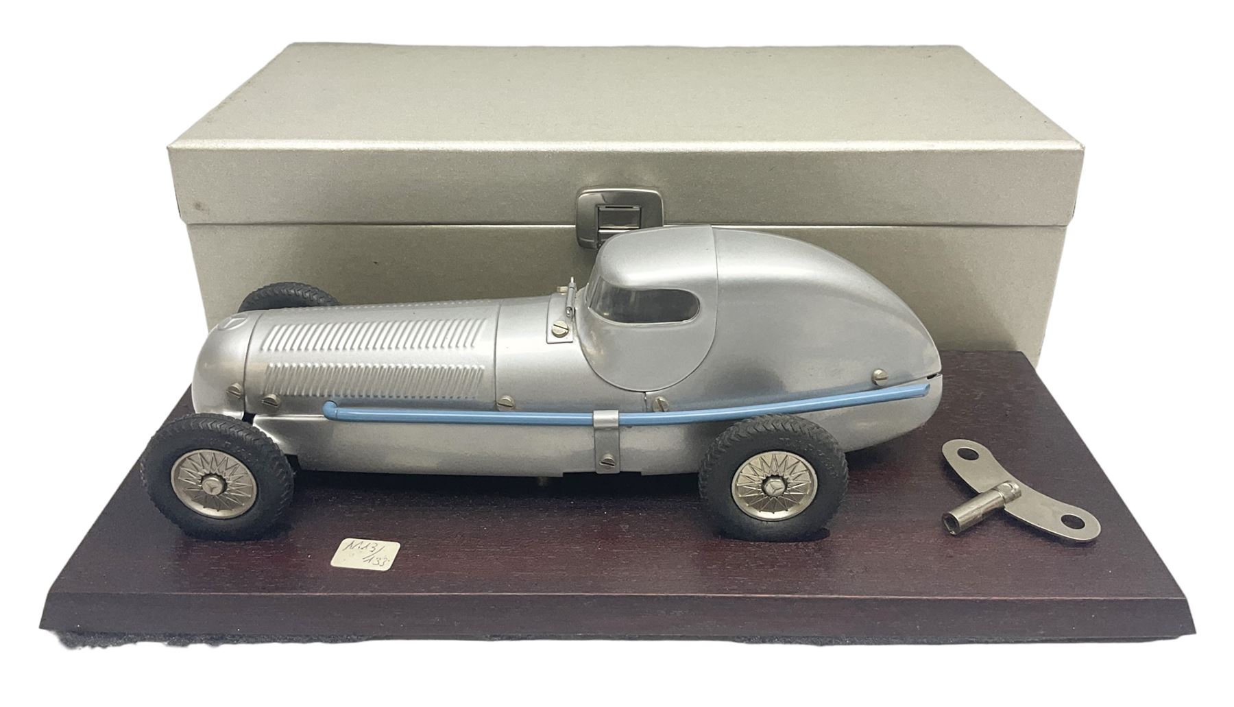 Marklin tin-plate clockwork Mercedes-Benz W25 racing car with driver in hinged cockpit model no.1096; fitted on mahogany base L33cm; in original metallic silver box with key