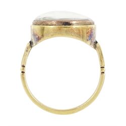 19th century gold portrait ring, set with an oval miniature of a woman wearing a pearl hairpin and earrings on ivory, under a glazed panel, set into a later gold ring with split shoulders. This lot has been registered for sale under Section 10 of the APHA Ivory Act
