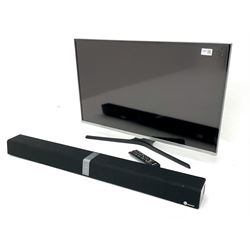 Samsung UE32J5100AK television with remote control and Taotronics sound bar