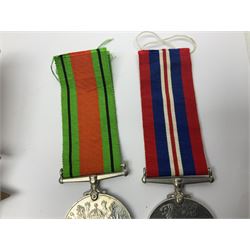 WWI pair of medals comprising British War Medal and Victory Medal awarded to 32682 Pte. W. Meadows W. Rid. R. in issue box; WWI pair of medals comprising 1914-15 Star and Victory Medal awarded to 3720 Pte. (later Cpl.) E. Petty W. York. R. with issue letter from Tank Corps; WWII group of five medals comprising 1939-45 War Medal, Defence Medal and 1939-45, Italy and Africa Stars; all with ribbons; and book of nineteen seaman's Certificates of Discharge to cook Charles Filburn 1893 - 1901 from various British ports
