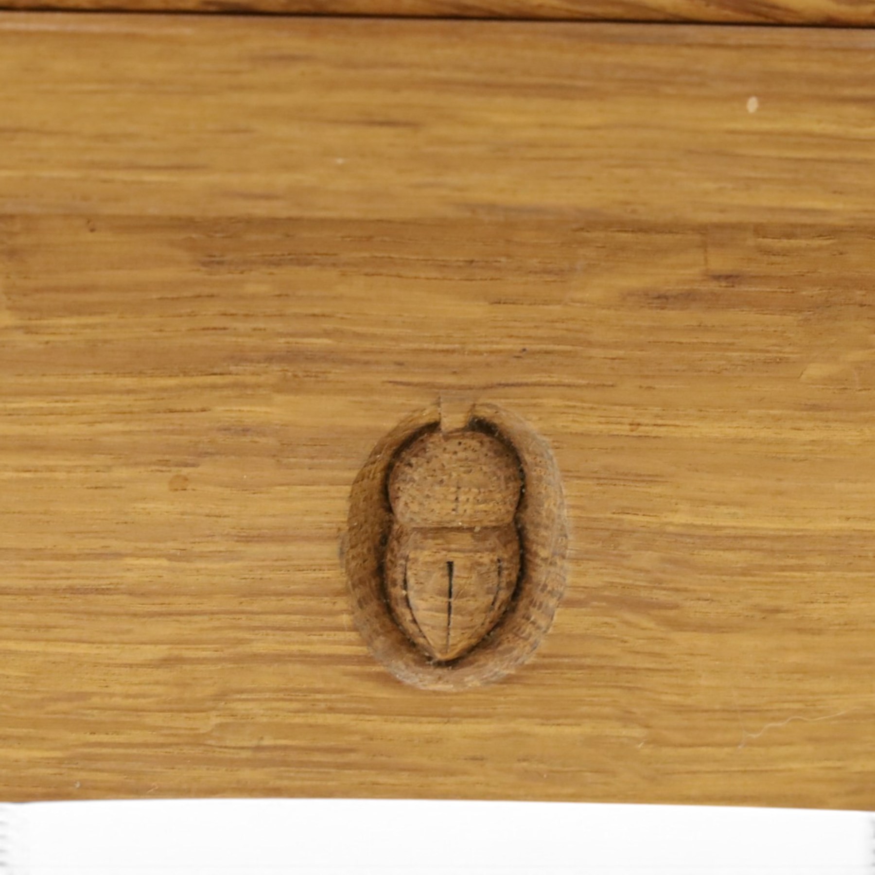 Acorn Industries - oak floor-standing corner cabinet, the top fitted with astragal glazed door enclosing four shaped shelves, the base with single panelled cupboard over two drawers, raised on four stepped feet, carved with acorn signature to top and base, by Alan Grainger, Brandsby