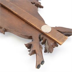 Late 19th century Continental carved wooden easel mirror, probably Black Forest, the shaped and bevelled mirror plate with surround carved with fruiting vines and surmounted with the figure of a cherub, with easel support verso, H72cm