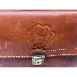 Tan leather holdall with three metal clasps to the front and impress decoration, together with another leather holdall; largest L55cm 