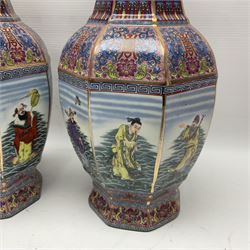 Pair of 20th century Chinese vases, of octagonal baluster form, each central panel decorated with one of The Eight Immortals, bordered by panels of floral motifs upon a pink/purple ground, H33.5cm