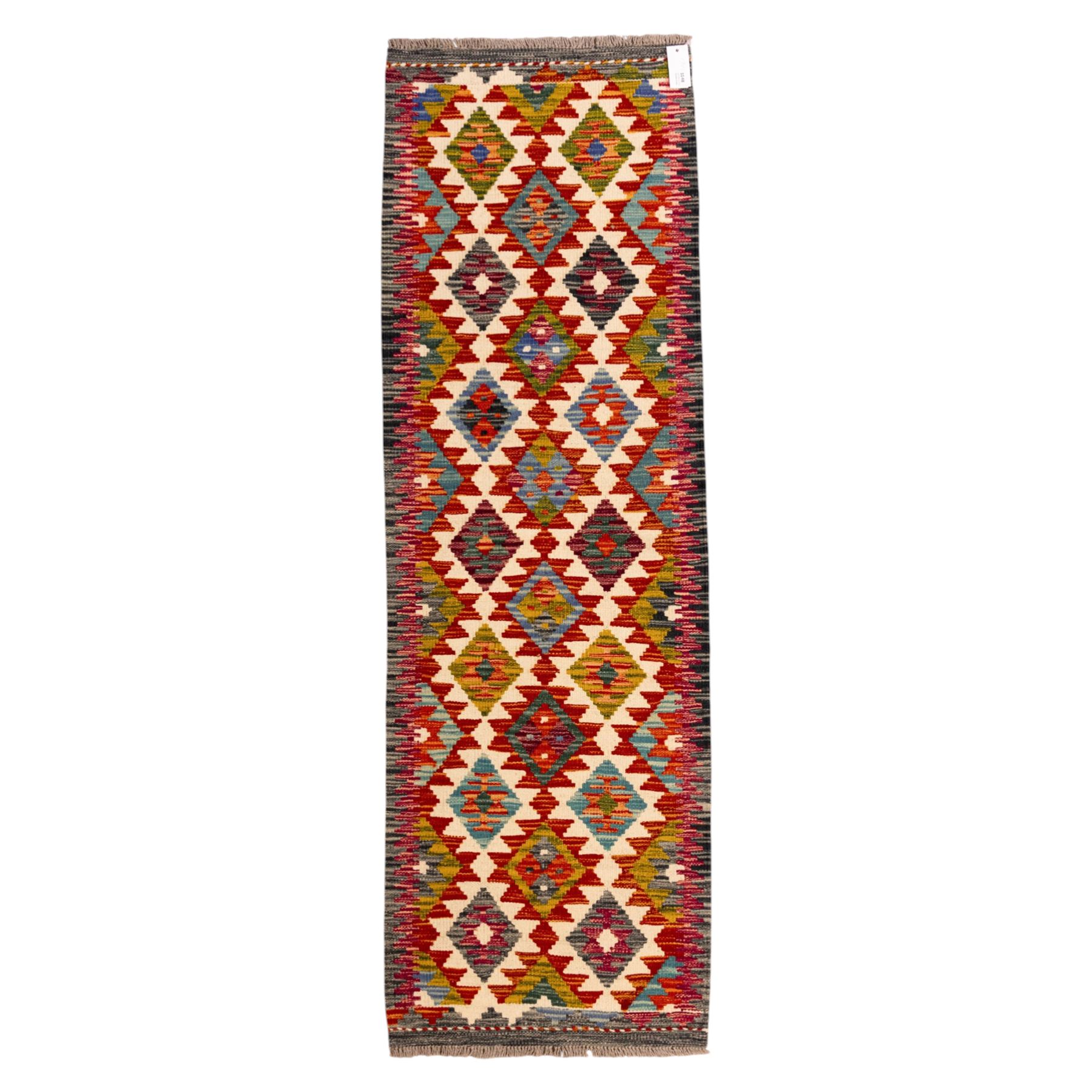 Afghan Chobi flatweave kilim runner, with a repeating stepped diamond medallion design in ivory, green, rust, teal, purple, indigo, and framed by chevron and geometric borders