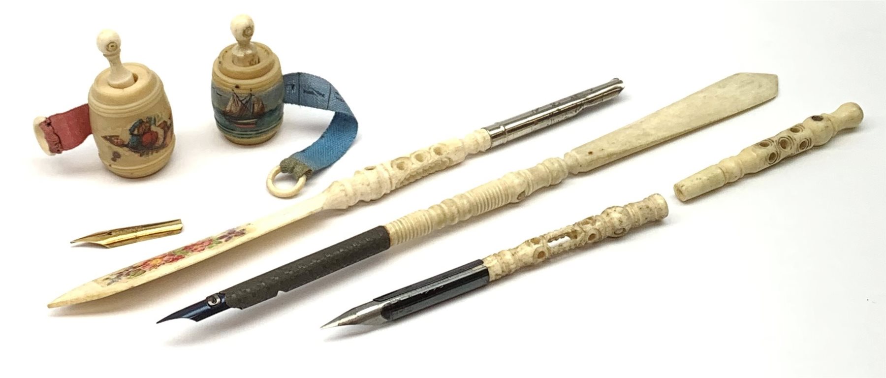 Two Victorian bone Stanhope pens with letter opener terminals, together with two further bone Stanhope pens (a/f), and two Victorian vegetable ivory Stanhope barrel tape measures. 