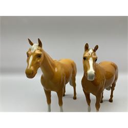 Two Beswick Palomino horse figures, comprising 'Imperial' Palomino, model no. 1557, designed by Albert Hallam and James Hayward, together with Palomino Arab model no. 1771, both stamped, tallest H20cm