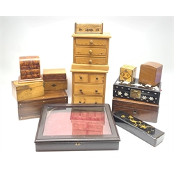 A 20th century mahogany table top bijouterie cabinet, the hinged glazed top opening to reveal a burgundy plush lined intrior, L41.5cm, together with two 19th century boxes each with mother of pearl panel to the cover, two modern pine miniature chest of drawers, a burr walnut example with domed top, etc. 
