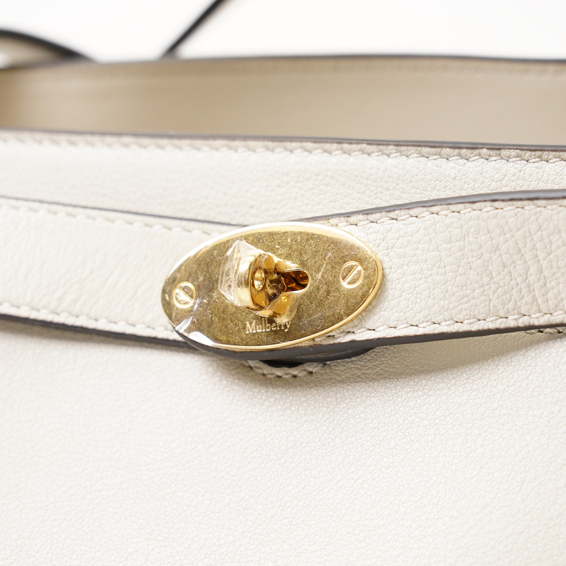 Mulberry - Islington handbag in Chalk Silky Calf leather with black piping, the structured body with single rolled top handle, gold-tone Postman’s Lock fastening and front strap detail, with detachable and adjustable shoulder strap, opening to a spacious two-division interior with Mulberry monogram fabric lining, with original Mulberry product tag, care booklet and dust bag, unused