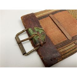 Late 19th century Yemeni Tuza jambiya as worn by religious elite, the 20.5cm curving blade with raised medial ridge, the horn hilt with pique style studwork, in a leather wrapped wooden scabbard with pierced metal mount and leather belt applied with embroidered 'gold' and 'silver' thread work panel; dagger L36cm overall, belt L84cm