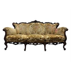 Victorian design stained wood three seater settee, top rail carved and scrolled, padded back and arms, scrolled cabriole feet 