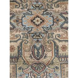 Ziegler-style machine-made rug, beige ground with a multicoloured central medallion and floral motifs, spandrels with scrolling designs, framed by a decorative border with intricate patterns