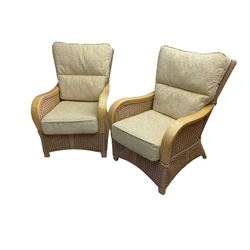 Contemporary rattan conservatory suite - two seat sofa with wicker frame and loose cushions upholstered in textured champagne fabric (W125cm H98cm); pair of matching armchairs (W72cm H98cm); rectangular glass-topped coffee table with rattan frame and undertier (W85cm D60cm H47cm); and matching square side table (W53cm H55cm)