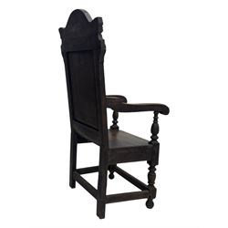 Late 19th century Jacobean revival carved oak armchair, the tall back with arched cresting featuring a stylised foliate mask, flanked by carved scrolls, relief carved panel depicting symmetrical foliage, downscrolled arms, on turned front supports united by stretchers